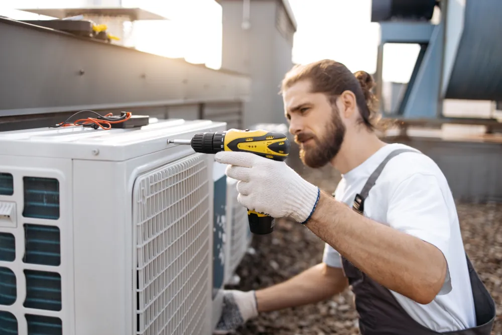 HVAC technician installing and air conditioner